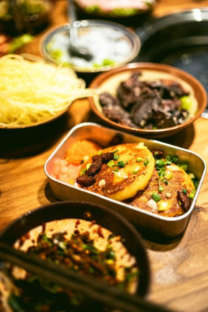 a-wooden-table-topped-with-different-types-of-food-vez5dbu73wg