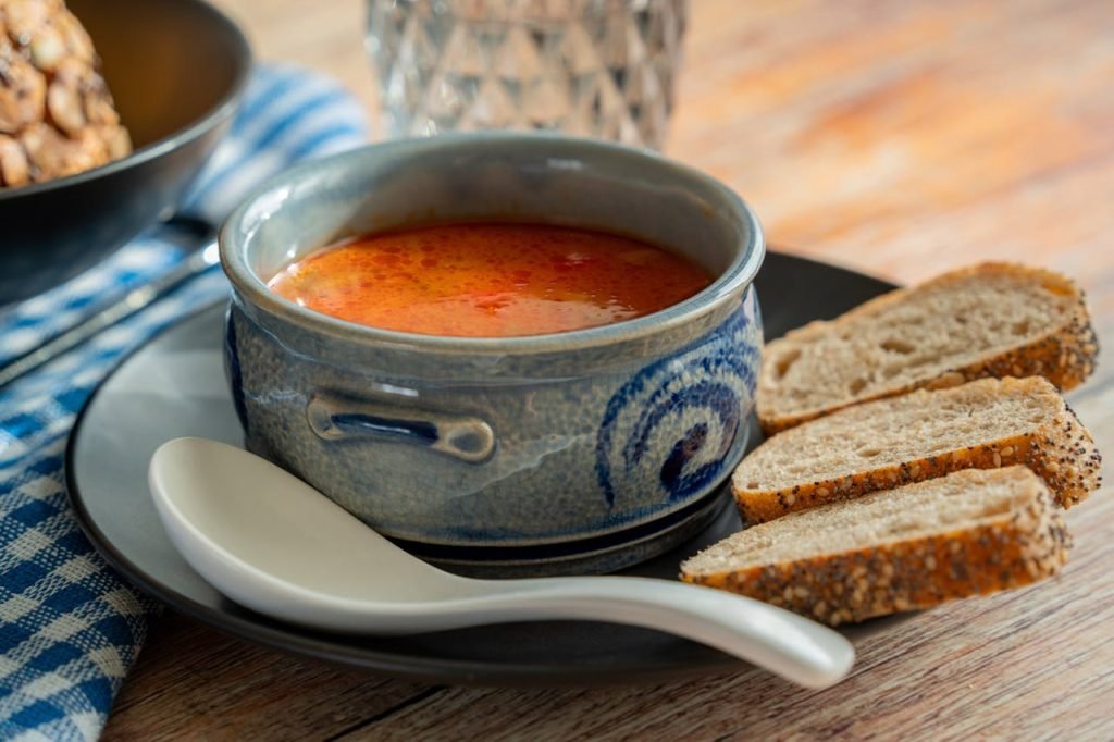 Delicious East European solyanka soup served with bread, perfect for a cozy meal.